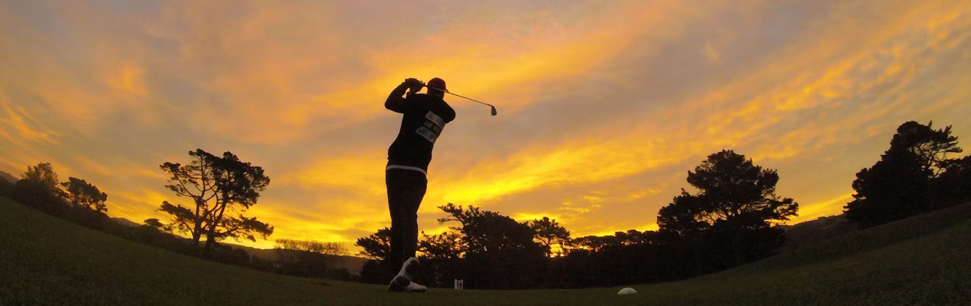 Golfer on fairway in the early morning.