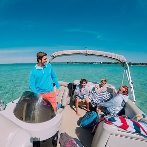 Happy family in a pontoon boat rental on the water