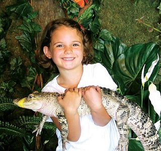 Girl holding an aligator at Fudpuckers