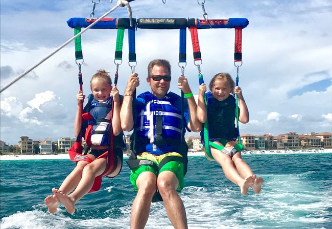 Dad and kids parasailing