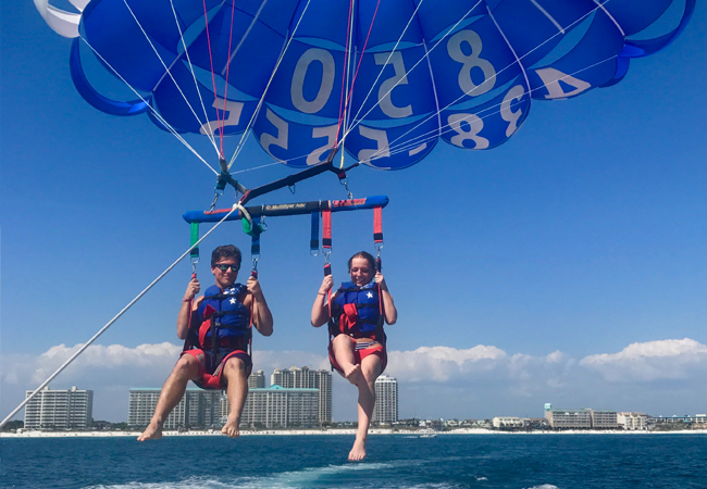 Parasailing in South Walton with rental condos in the background