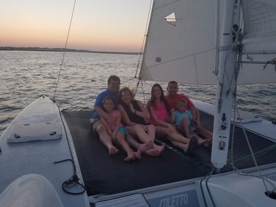 Family taking a sunset catamaran cruise in 30A
