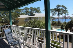 A view of the pool and water from the balcony.