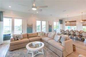 Multiple sliding glass doors lead out to the deck, giving you sweeping views of both the turquoise waves of the Gulf and the calm, indigo oasis of Allen Lake.