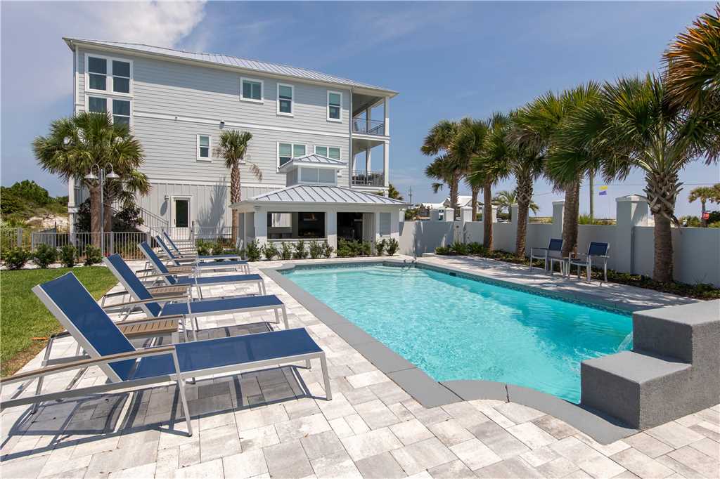 This luxury beach house for rent in Inlet Beach can accommodate very large groups! It has a wonderful pool, tropical landscaping, and lots of room to stretch out and relax.