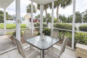 The screened porch overlooks the pool.