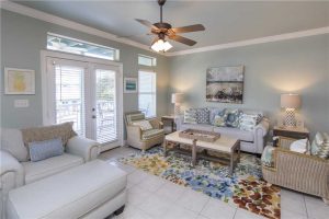 The living area of this spacious beach rental with relaxing coastal decor.