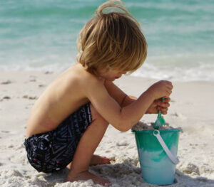 Child plays near his winter vacation rental on 30A, FL.