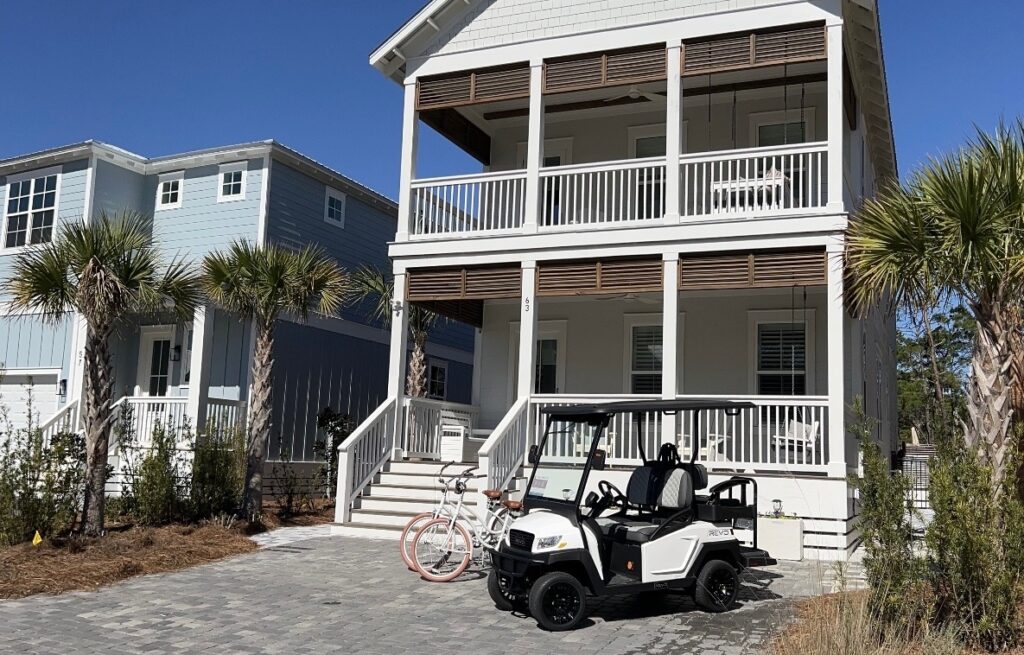 Dune allen beach vacation rental with golf cart out front.