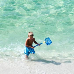 Boy on the beach having fun near his 30A FL vacation rental home.